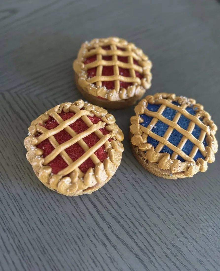 Three mini lattice cookie pies filled with cherry and blueberry