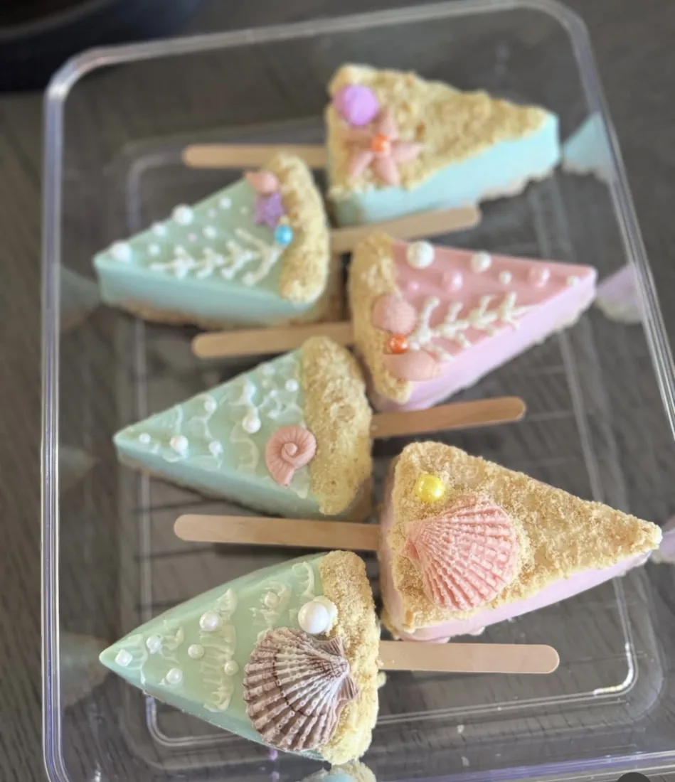 Boxed assortment of mint and pink beach Rice Krispie treats with shells, coral and sugar pearls